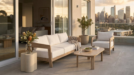 Outdoor sofa set with white cushions and coffee table on balcony