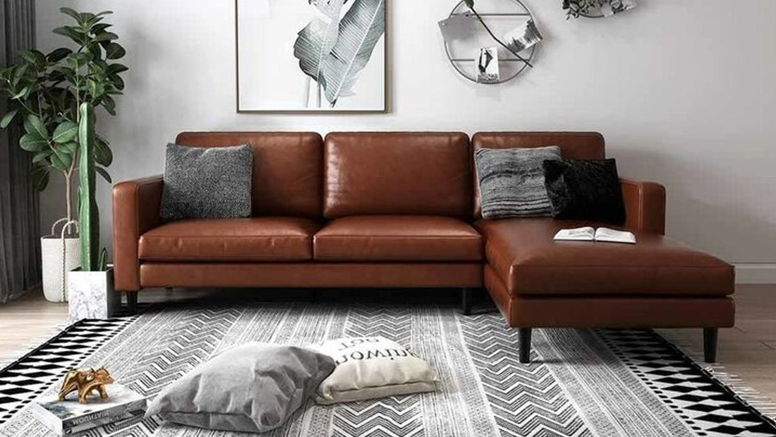 Cozy living room decorating ideas for autumn featuring a brown leather chaise sofa, plush cushions, and a patterned rug for a warm, inviting space.