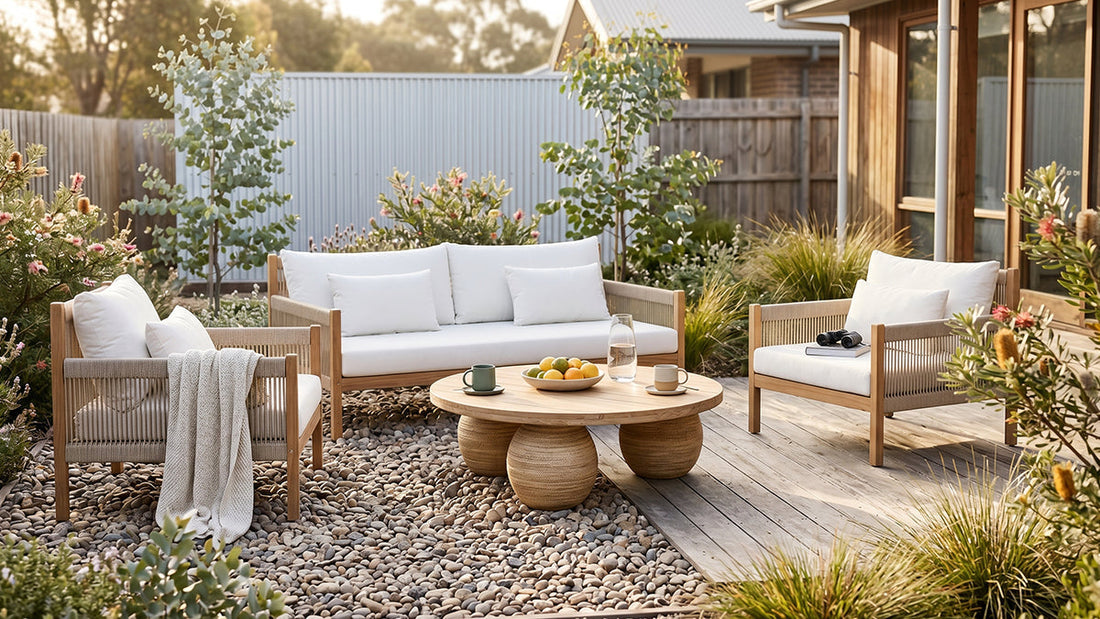 Timber outdoor lounge set with white cushions and round coffee table