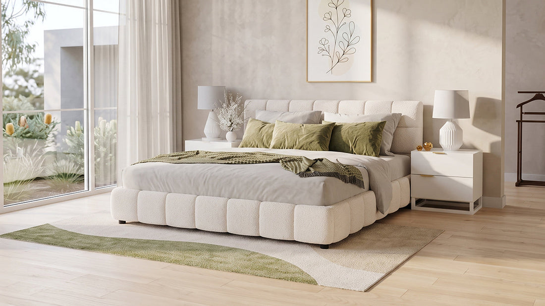 Cream upholstered bed with green cushions in bright neutral bedroom