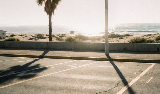 An empty beachside parking lot with a view of the ocean, highlighting the convenience of private parking in coastal areas.