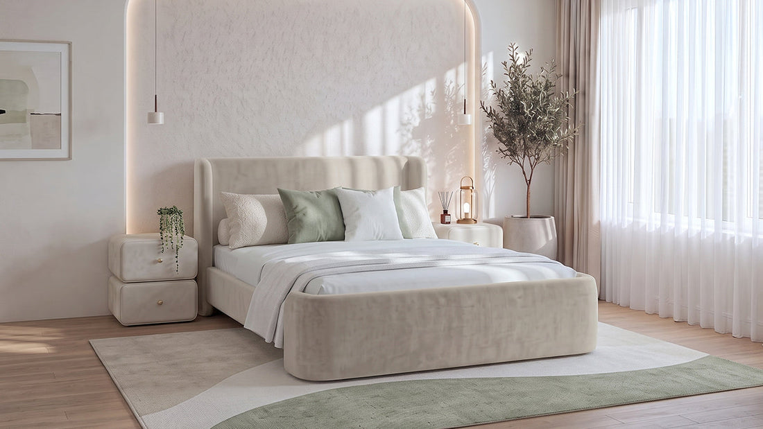 Cream upholstered bed with sage cushions in bright neutral bedroom