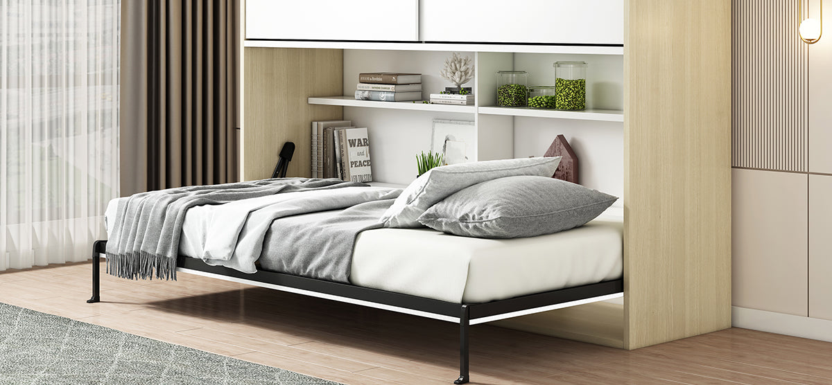 Modern bedroom corner with wall-mounted Murphy bed, neutral bedding, built-in shelves with decor, large window with sheer curtains, light wood floor, and simple wall-mounted light fixture.
