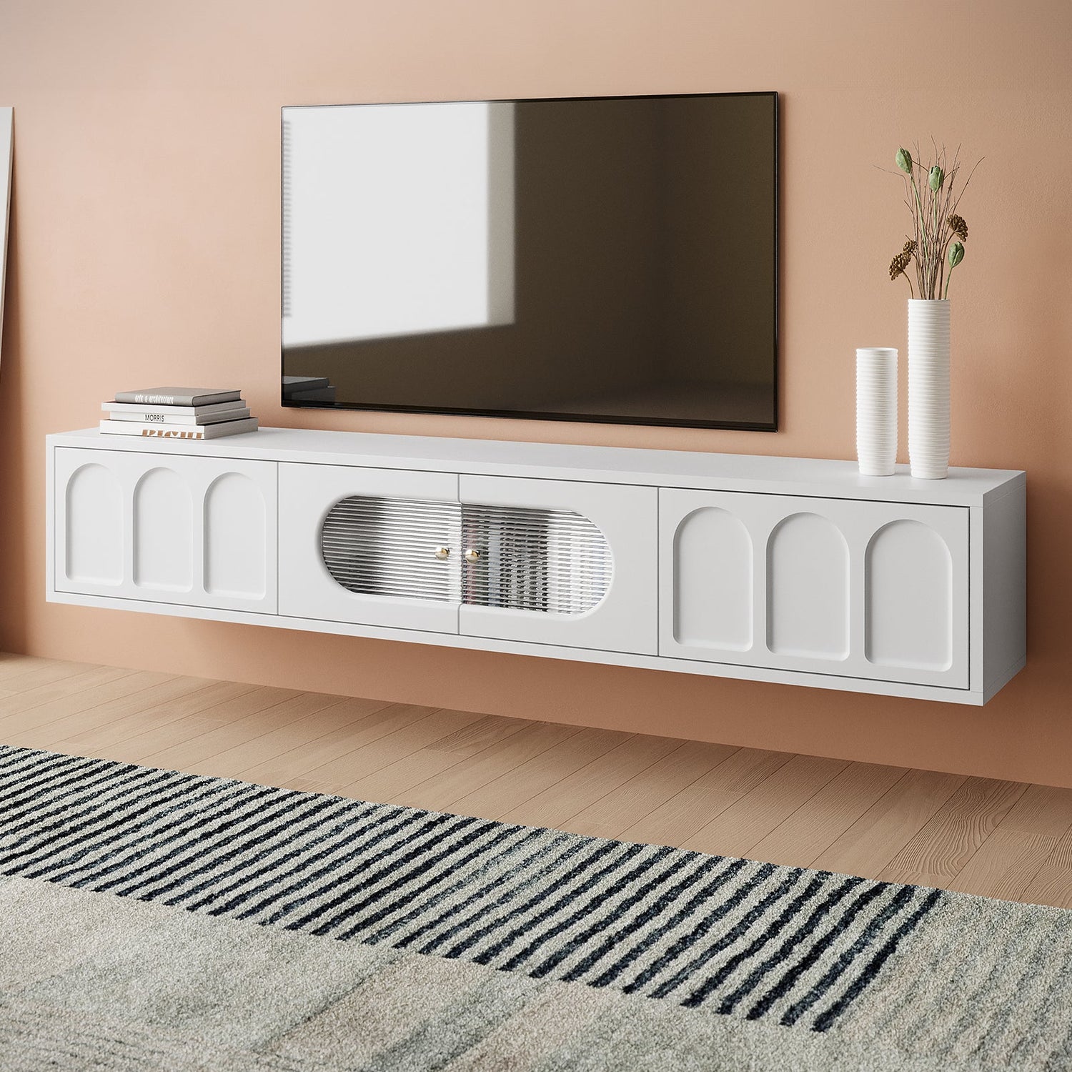 Floating white entertainment unit with arched panel doors and a central fluted glass insert