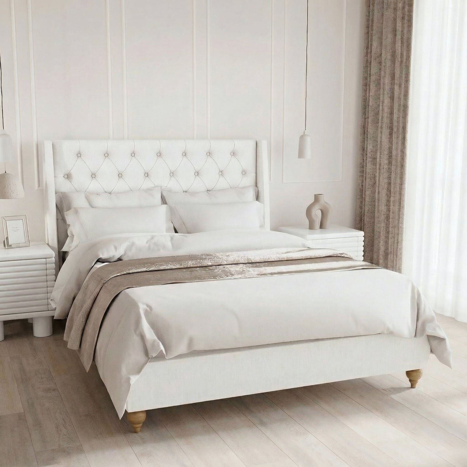 Elegant double bedroom featuring a white button-tufted headboard, crisp white bedding with a champagne throw, and white fluted nightstands. The minimalist space includes subtle wall paneling, a hanging pendant light, and sheer floor-to-ceiling curtains.