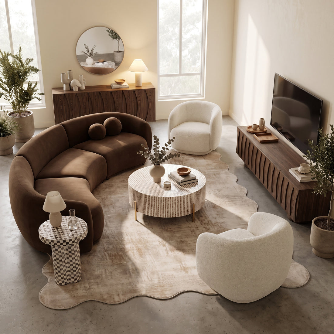 Curved brown velvet sectional sofa paired with two cream bouclé armchairs, a round coffee table, and a wooden TV unit in a neutral living room space.