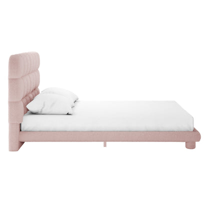 Aina Queen Bouclé Bed Frame in Pink features a plush, vertically tufted headboard and matching frame, upholstered in soft pink bouclé fabric, with a white mattress and pillows on a white background.