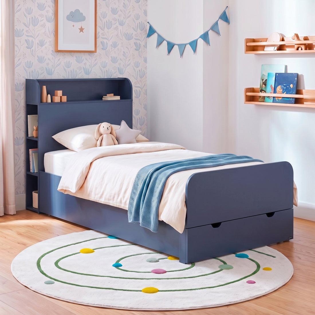 Blue children's bed styled in a bright decorated bedroom