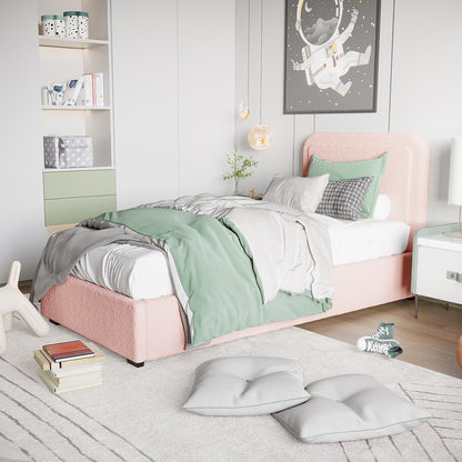Carya Kids Single Fabric Bouclé Bed Frame in Light Pink, featuring a soft, upholstered design with white sheets, a pale green duvet, and patterned pillows, set in a pastel-toned bedroom.
