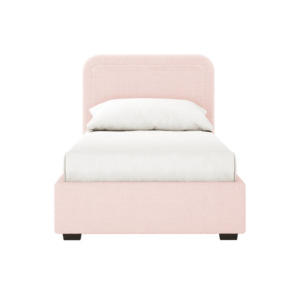 Carya Kids Single Fabric Boucle Bed Frame in Light Pink, featuring a blush-pink boucle-upholstered frame and headboard, white linens, and dark-stained wooden legs, offering a modern, cozy design.
