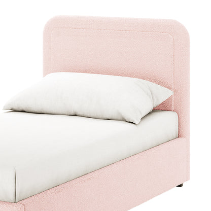 Carya Kids Single Fabric Bouclé Bed Frame in Light Pink, featuring a pastel-pink upholstered headboard and side rails, white mattress, and pillow. Luxurious bouclé fabric adds a soft, sophisticated touch.