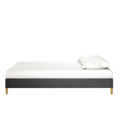 Celina Boucle Upholstered Fabric Bed Base - Black Queen features a dark-gray upholstered platform design with short wooden legs, topped with a white mattress and pillow against a plain white background.