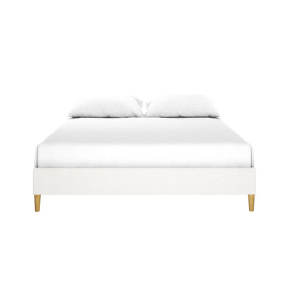 Celina Queen Boucle Fabric Bed Base in Cream White features a low-profile design with white upholstery, foam padding, and light-wood tapered legs, offering a modern, stylish touch to any bedroom.