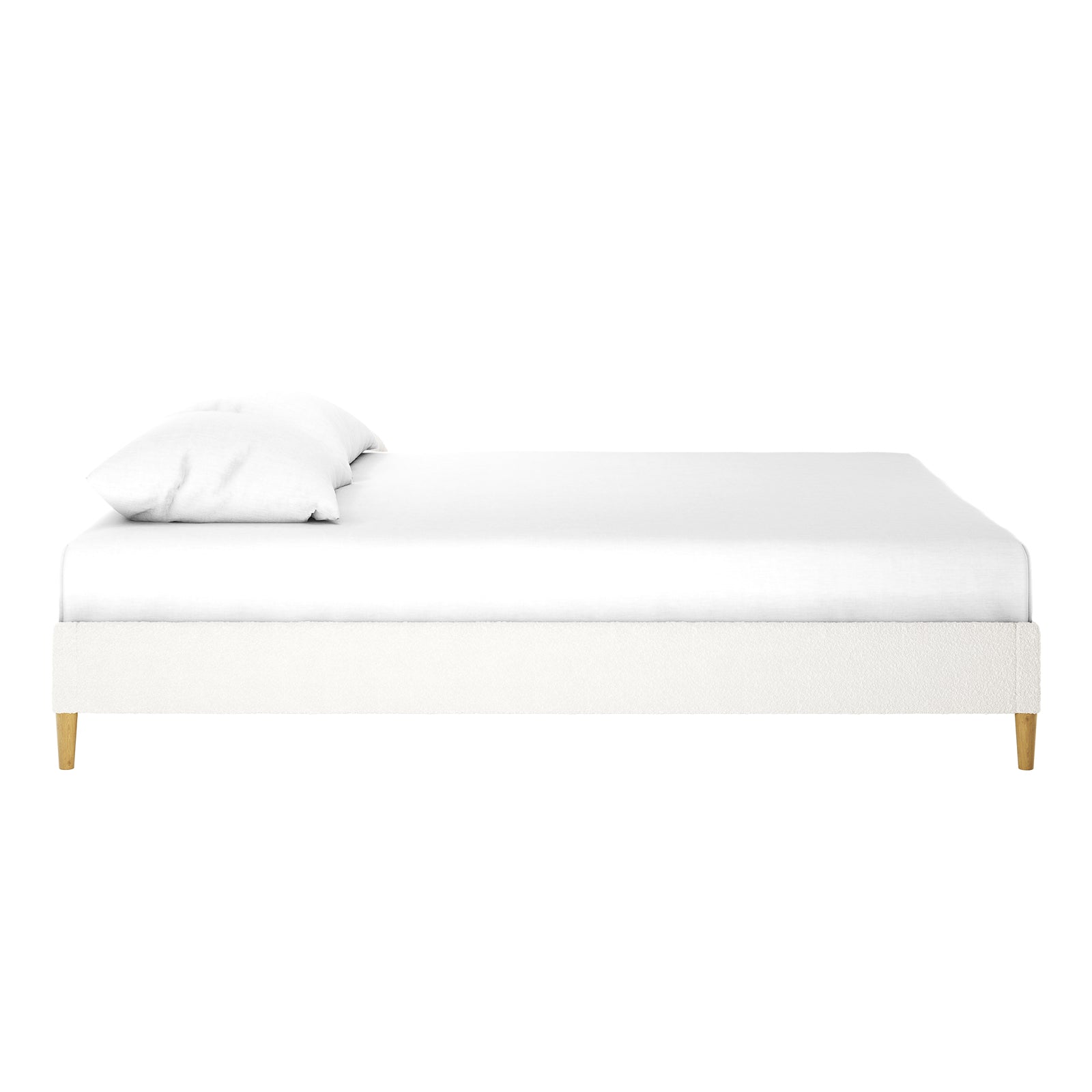 Celina Queen Boucle Fabric Bed Base in Cream White features a minimalist, low-profile upholstered frame on short wooden legs, topped with a white mattress and two pillows, showcasing luxury and modern design.