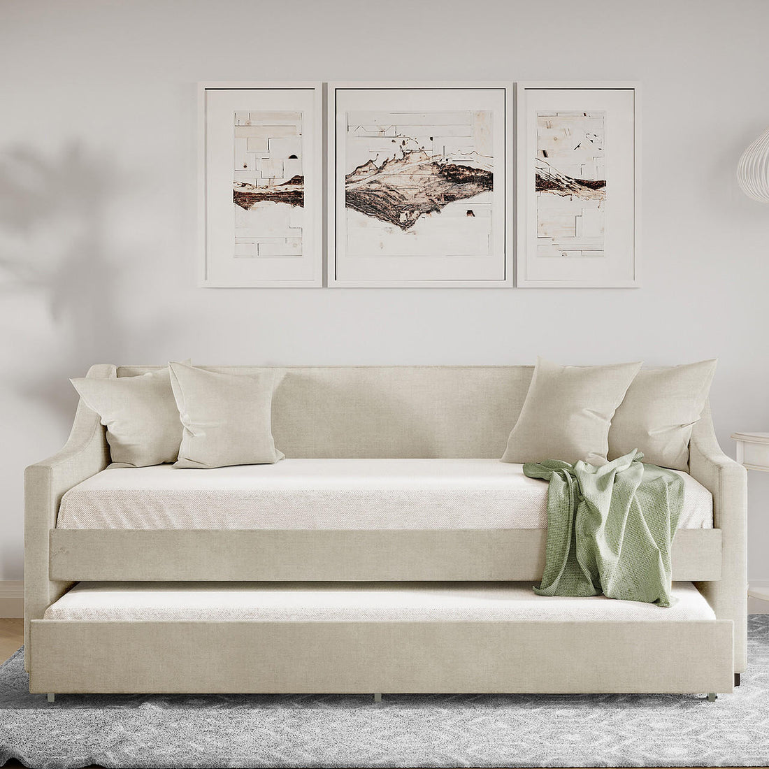 Cloelia Linen Single Sofa Daybed with Trundle - Beige, showcasing its elegant linen fabric and scatter cushions, positioned on a couch with a green blanket, highlighting its dual functionality for comfort and style.