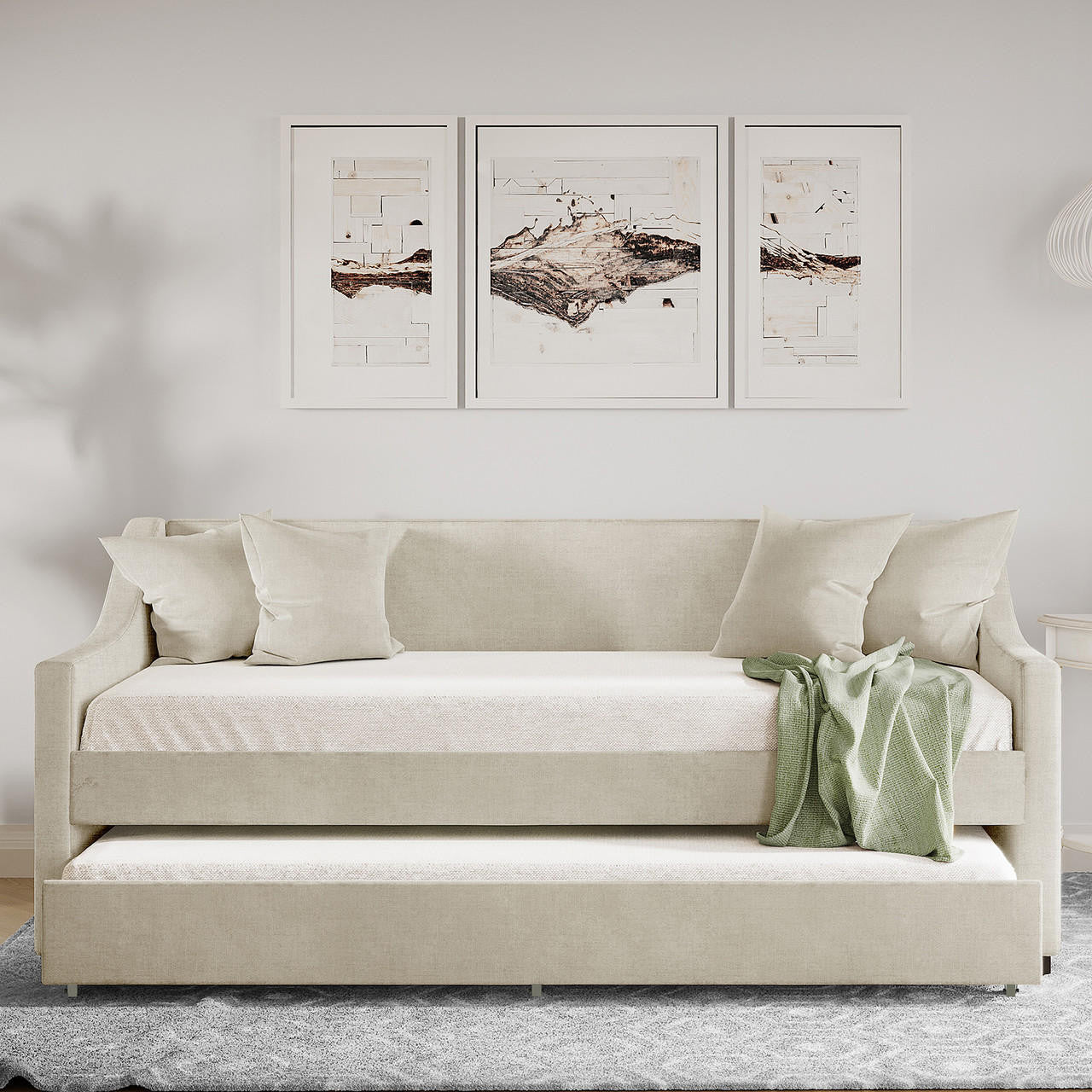 Cloelia Linen Single Sofa Daybed with Trundle - Beige, showcasing its elegant linen fabric and scatter cushions, positioned on a couch with a green blanket, highlighting its dual functionality for comfort and style.