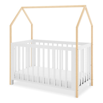 Damaris Solid Pine Baby Cot Bed - White/Natural features a house-shaped frame with a white base and natural wood posts forming a pitched roof, creating a playful, convertible nursery bed.