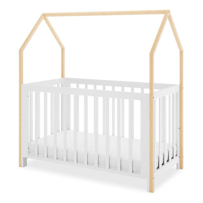 Damaris Solid Pine Baby Cot Bed - White/Natural features a house-shaped frame with a white base and natural wood posts forming a pitched roof, creating a playful, convertible nursery bed.