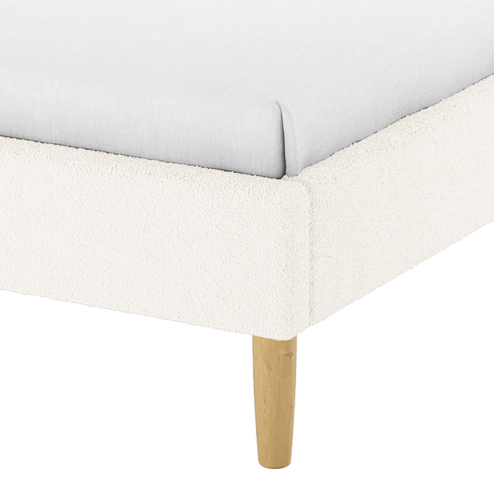 Close-up of the Estilla Single Rainbow Boucle Bed Frame in Cream White, showcasing its light boucle-style upholstered corner and wooden leg, emphasizing its cosy and whimsical design for kids or guest rooms.