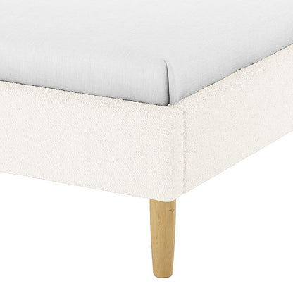 Close-up of the Estilla Single Rainbow Boucle Bed Frame in Cream White, showcasing its light boucle-style upholstered corner and wooden leg, emphasizing its cosy and whimsical design for kids or guest rooms.