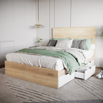 Fabiola Queen Storage Bed Base with Drawers in White & Oak features a wooden platform with built-in under-bed storage, white linens, a sage-green blanket, and a modern pendant light.