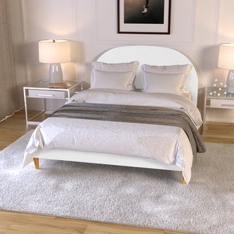 Fausta Bouclé Bed Frame with Arch Headboard - Cream White Double in a modern bedroom, featuring a softly curved headboard, crisp white bedding, and matching nightstands with ceramic lamps.