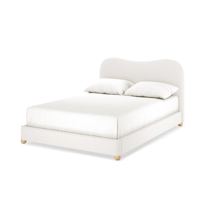 Ginnie Bouclé Curved Double Bed Frame in cream white with a low-profile fabric frame, matching softly curved headboard, two white pillows, and natural wood bun feet, showcasing modern elegance.
