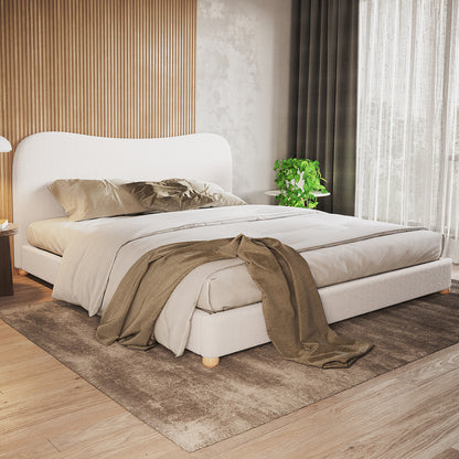 Ginnie Curved Bouclé Bed Frame - Cream White, features a low-profile design with a curved headboard, upholstered in soft bouclé fabric. Styled with neutral linens and a taupe-brown throw in a minimalist bedroom.