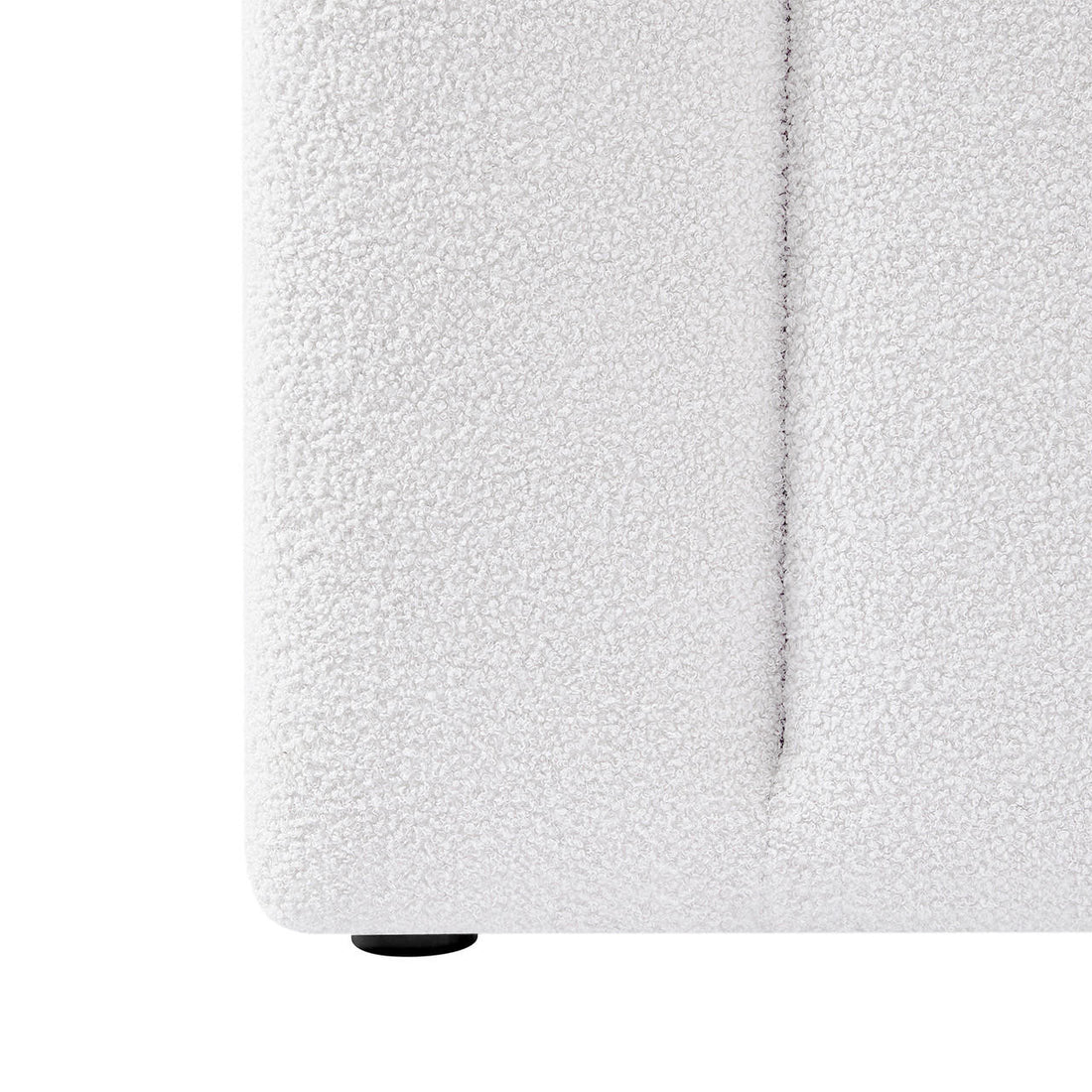 Close-up of Aquila King Extra Wide Bouclé Headboard in Cream White, showcasing the textured bouclé fabric, visible seam, and a small black foot at the base.
