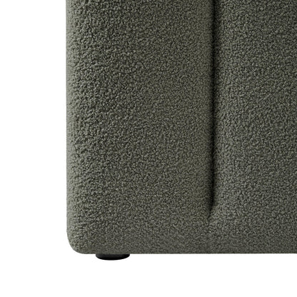 Close-up of the Aquila King Extra Wide Headboard & Fabia Gas-lift Storage Bed Base Set, showcasing the muted gray-green bouclé fabric and a small round black foot underneath.