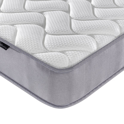 Harel & Vesta Slide Bunk Bed & Vesta Mattress Set in Natural, highlighting the quilted mattress pad's white, textured top and grey fabric side wall wrapping around the mattress corner.
