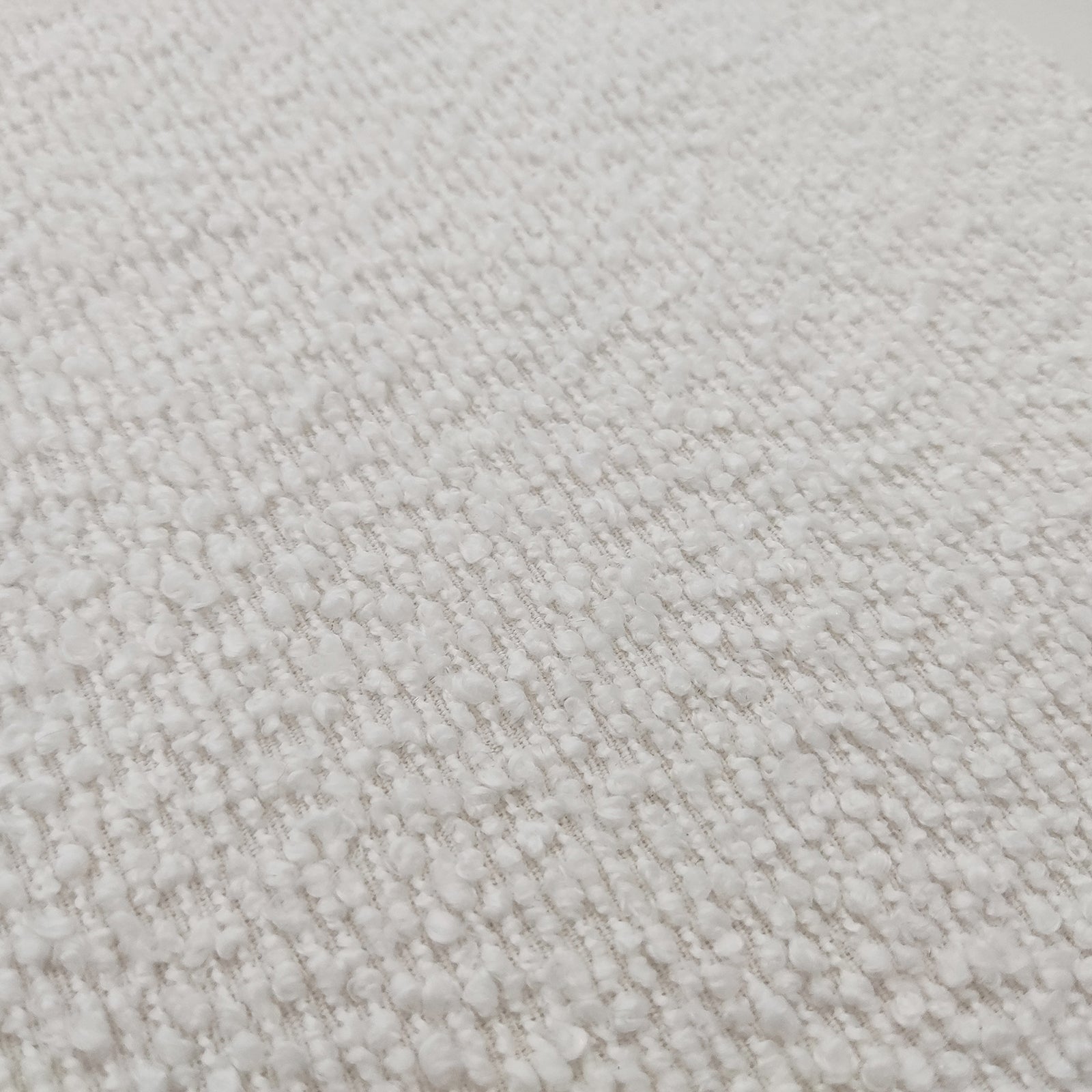 Close-up of the Harper Boucle King Bed Frame in eggshell white, showcasing its plush boucle upholstery and sturdy eucalyptus hardwood frame, highlighting the bed's modern sophistication and designer collaboration details.
