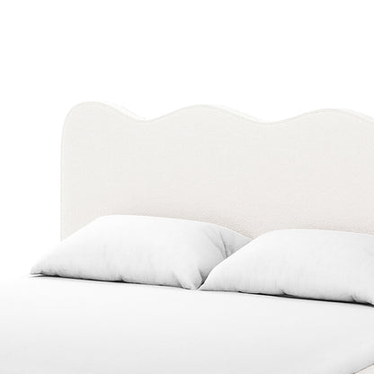 Kaylie Double Boucle Fabric Bed Frame in Cream White features a softly upholstered headboard with a wavy silhouette, accompanied by a low-profile mattress and two white pillows, exuding modern elegance and comfort.