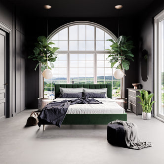 Kelly King Velvet Bed Frame – Dark Forest Green features a tufted headboard and solid wood frame, showcasing opulent design and functionality in a bedroom setting with a large window.