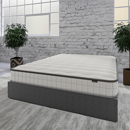 Logan & Cybele Queen Murphy Bed & Mattress Set in White features a sleek light-grey mattress on a dark-grey base, set in a minimalist room with potted plants and a whitewashed brick wall.