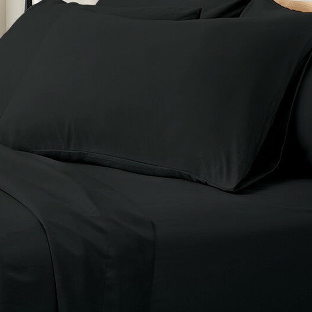 Valeria 1000TC Ultra Soft Bed Sheet Set King Single – Black displayed on a bed, showcasing its luxurious, sleek fabric and modern design with a person sitting nearby for scale.