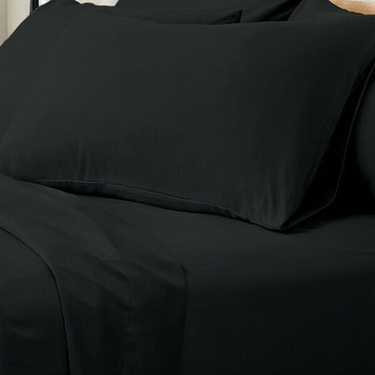 Valeria 1000TC Ultra Soft Bed Sheet Set King Single – Black displayed on a bed, showcasing its luxurious, sleek fabric and modern design with a person sitting nearby for scale.