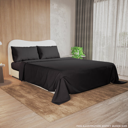 Valeria 1000TC Ultra Soft Bed Sheet Set Queen – Black displayed on a bed, showcasing its smooth texture and luxurious appearance, with a plant in the background enhancing the elegant bedroom setting.