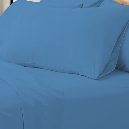 Valeria Super King 1000TC Ultra Soft Bed Sheet Set in Blue on a bed, showcasing solid blue sheets with a matching pillowcase and flat sheet, highlighting its luxurious and comfortable appearance.