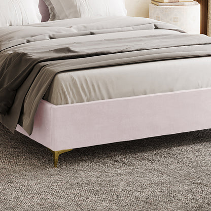 Lyra Velvet Bed Frame with Winged Headboard - Soft Pink Double, featuring blush-pink velvet upholstery, gold-metal legs, and a tufted headboard, topped with neutral sheets and a gray duvet.