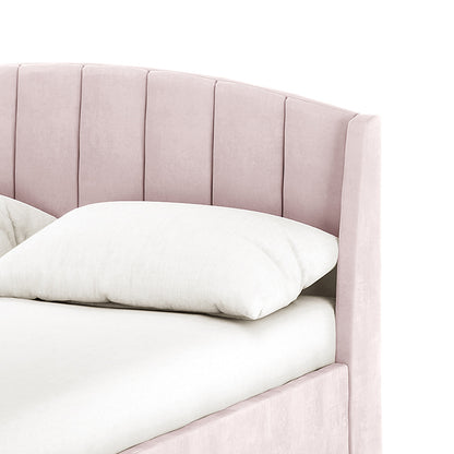Lyra Velvet Bed Frame with Winged Headboard - Soft Pink Double features a blush-pink, vertically channeled headboard, dressed in plain white bedding, showcasing its elegant and inviting design.
