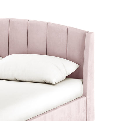 Lyra Velvet Bed Frame with Winged Headboard - Soft Pink King features a curved, channel-stitched headboard in soft pink velvet with a white pillow resting on a white mattress.