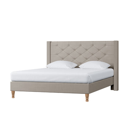 Maggie Queen Winged Fabric Bed Frame in Warm Grey features a tall, button-tufted headboard, low-profile frame, turned wooden legs, white mattress cover, and pillows, embodying elegance and stability.
