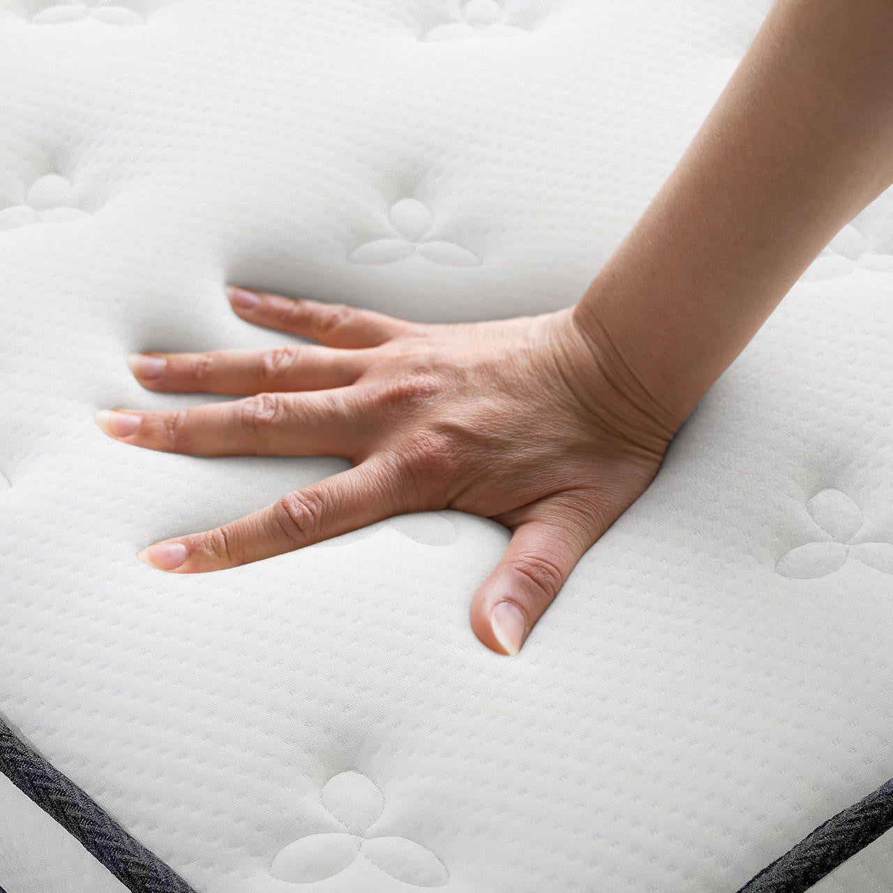 Close-up of a hand pressing the plush, tufted surface of the Antheia King 32cm Euro Top Memory Foam King Latex Mattress in Medium Firm, showing the foam indentation for comfort and support.
