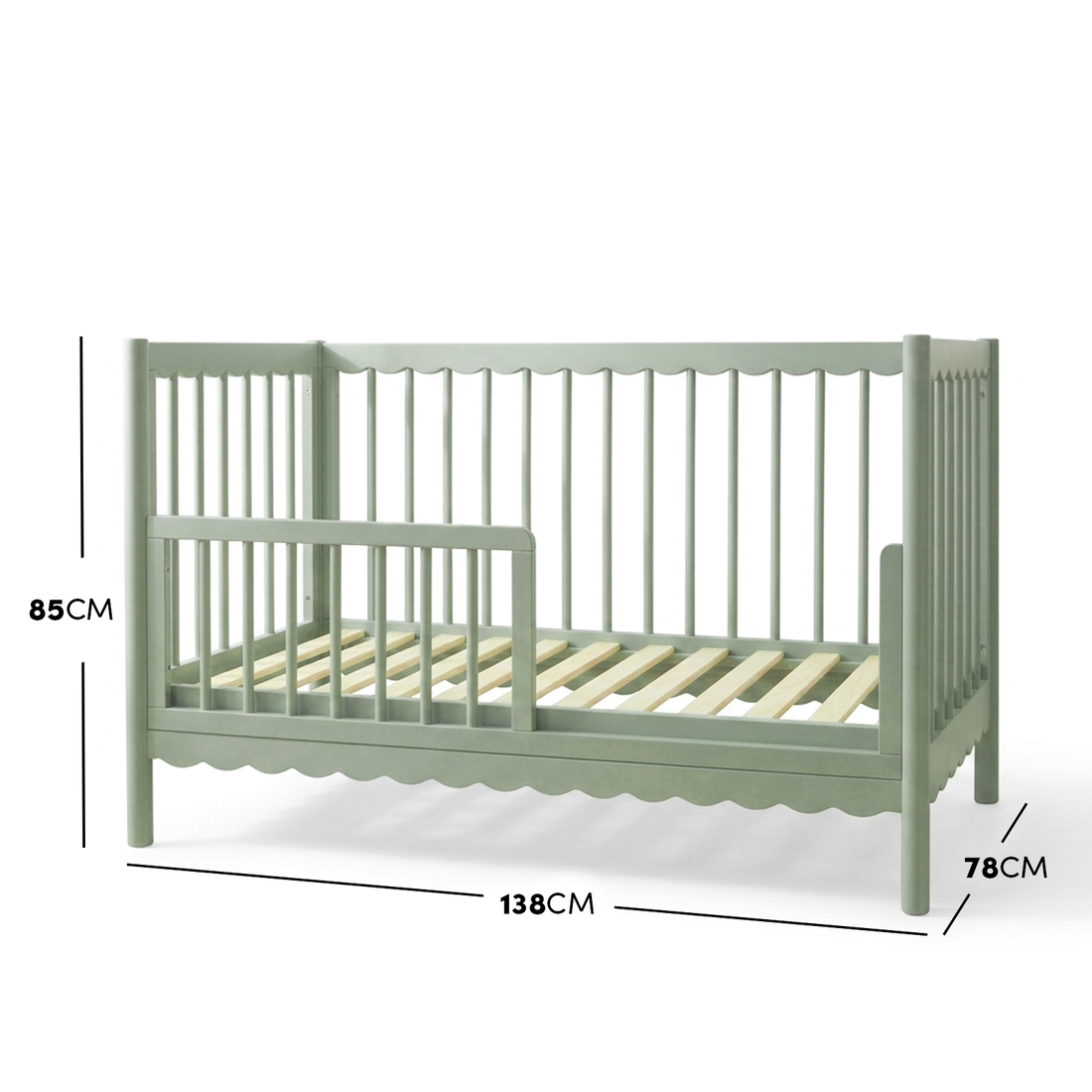 Sage green timber toddler bed with scalloped base molding and dimensions diagram.