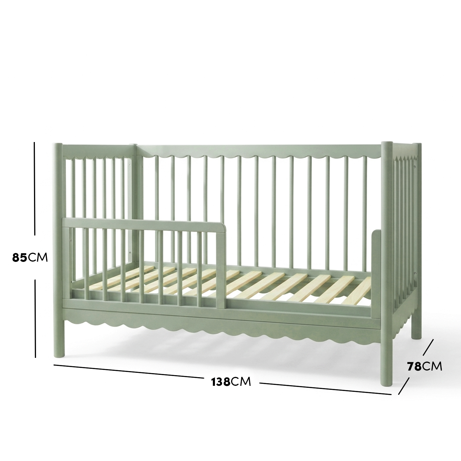 Sage green timber toddler bed with scalloped base molding and dimensions diagram.