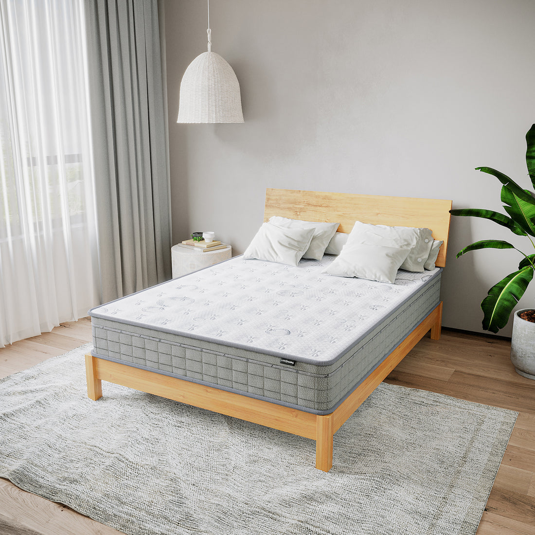 Thetis Double 25cm Pocket Spring Latex Mattress in Med Firm, with a white quilted cover, rests on a wooden bed frame surrounded by gray pillows, a woven lamp, and a textured rug.