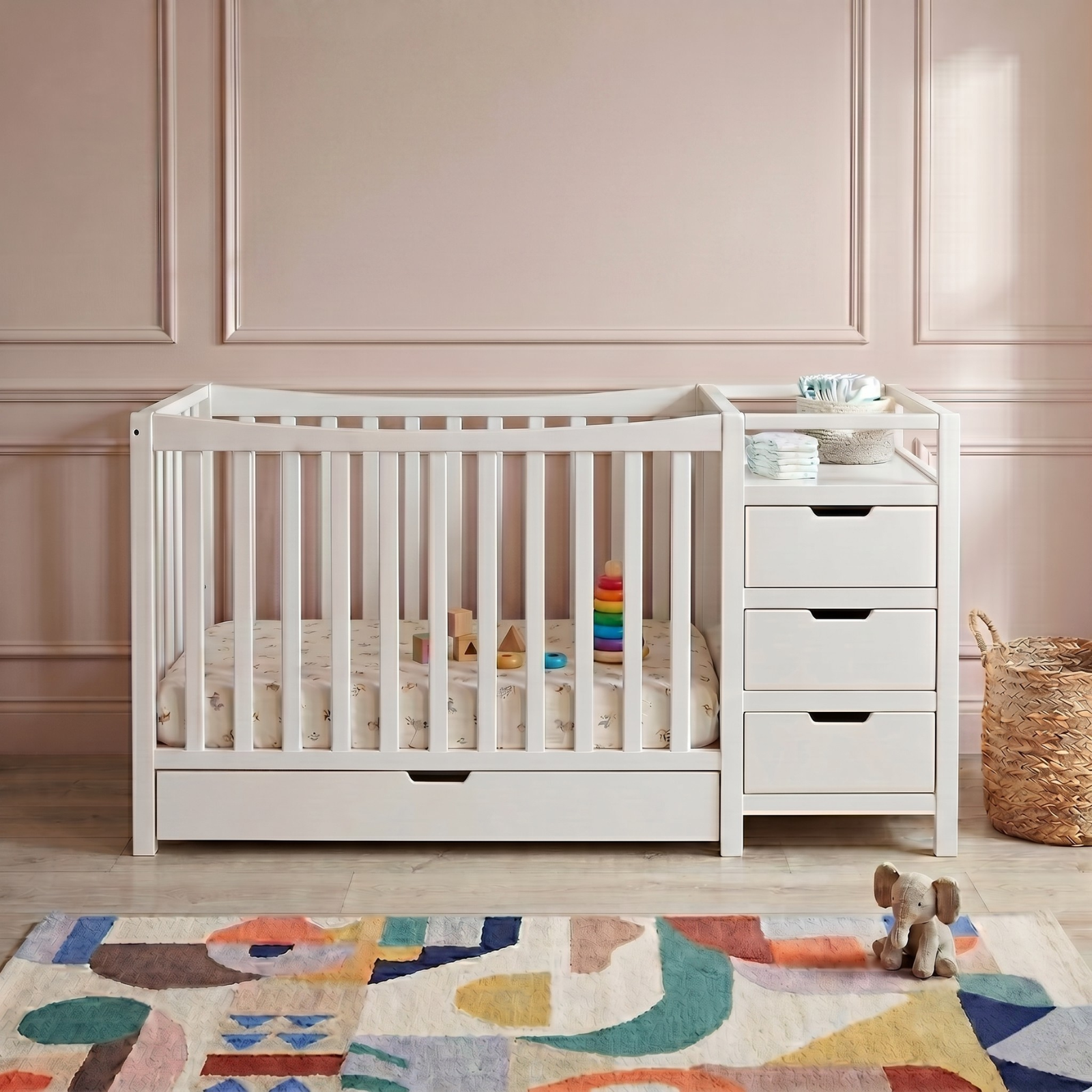 Modern white timber infant crib with an attached storage chest and changing station in a nursery.