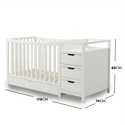 Natural wood and white infant crib featuring an attached storage chest with measurements.