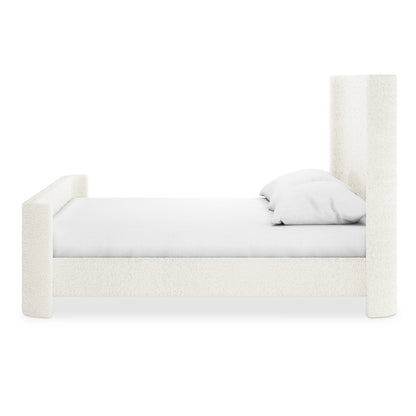 Palmira Queen Boucle Fabric Bed Frame in Cream White, featuring a tall headboard and shorter footboard with off-white bouclé upholstery. Sleigh silhouette supports a mattress with white linens and pillows.
